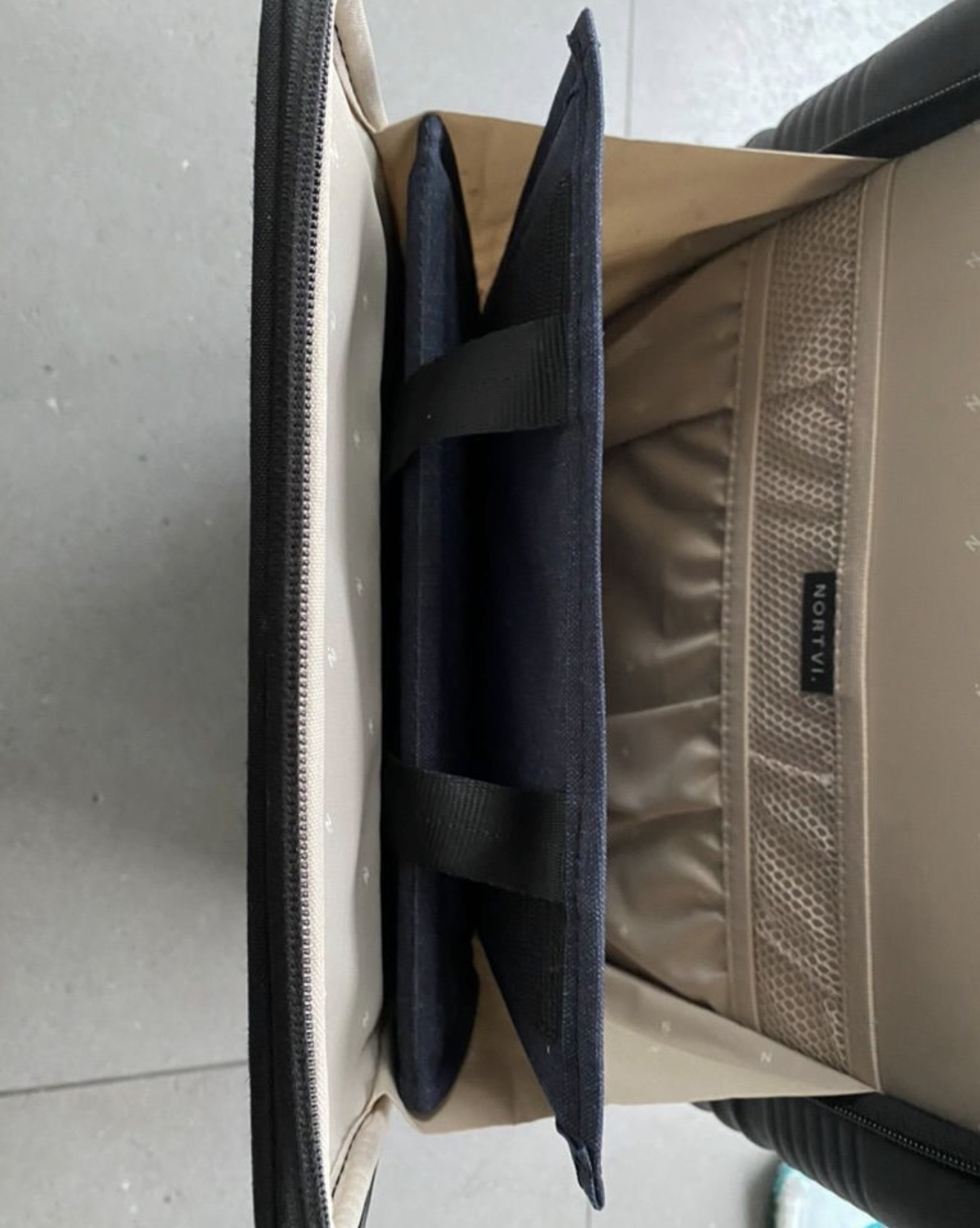 Aero Footrest packed flat along the side of a carry-on